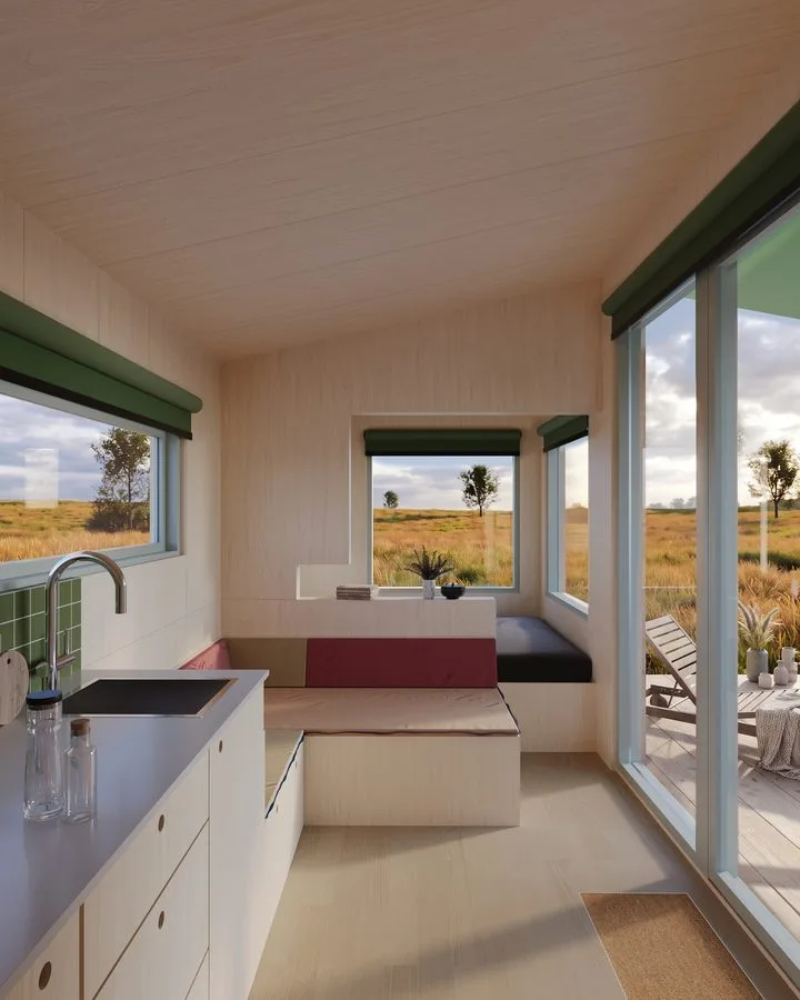 Render of the THOW 3 interior: kitchen unit and upholstered window seat, glazing fully open to the meadow
